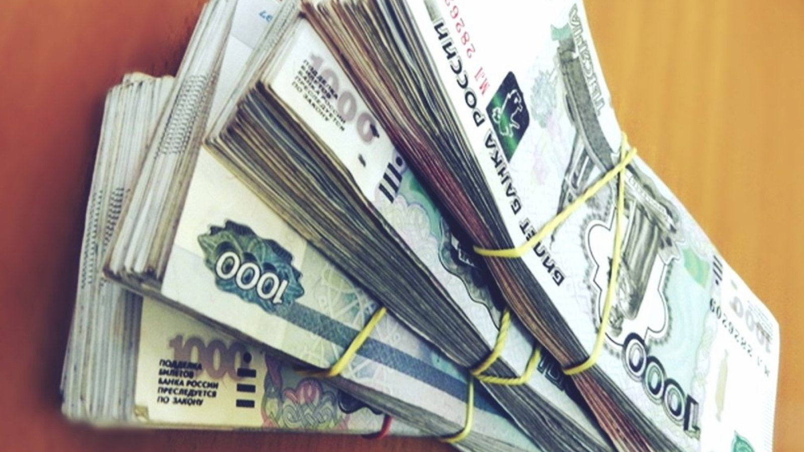 Пачки денег по 1000 рублей