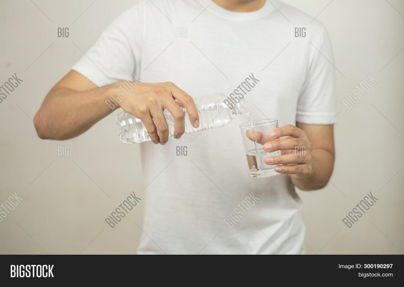 Человек держит в руке бутылку